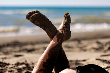 Sandy feet relaxed against a sunlit beach backdrop, a moment of summer bliss