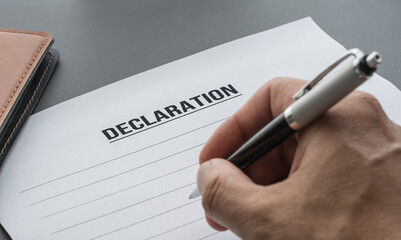 Hand holding a pen ready to write a statement. writing a statement
