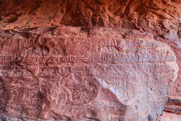 close up of 2000 years old Anfashieh inscriptions of Khazali canyon from the ancient bedouin nomads, etched into the rock surfaces of Jordan's majestic Wadi Rum desert