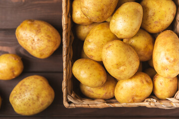 Young potatoes. Fresh potatoes  on a wooden background.Harvesting collection. organic, freshly dug potatoes. Agricultural background. Vegan. Vegetables.Place for text.Copy space