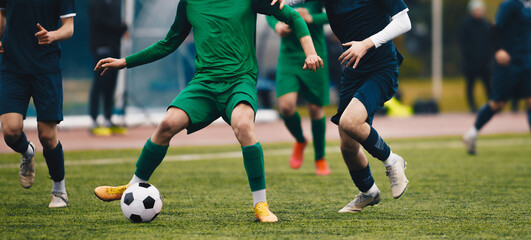 Adult soccer football player  kick a ball during match in the stadium. Soccer forward dribbling...