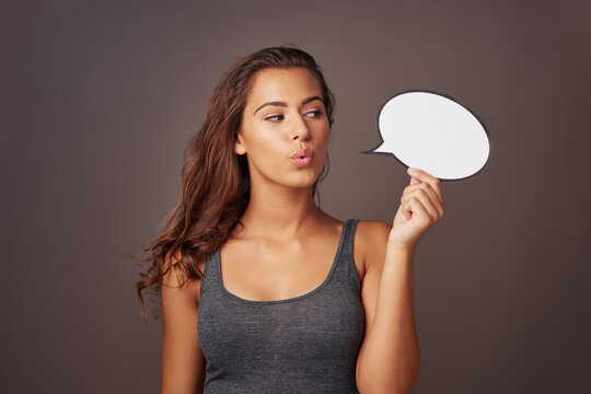 Speech bubble, omg and woman in studio with sign for communication, opinion and feedback. Mockup space, social media and person with poster for information, announcement and emoji on dark background