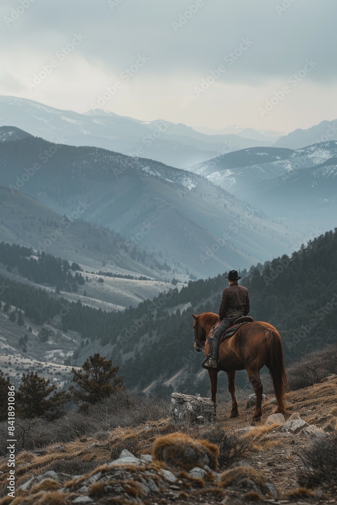 Canvas Prints A person riding a horse at the summit of a mountain, offering breathtaking views