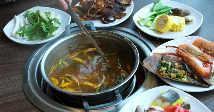 broth with vegetables Stirred ladle chicken with noodles and potatoes cold soup in a small saucepan on the gas stove near the window