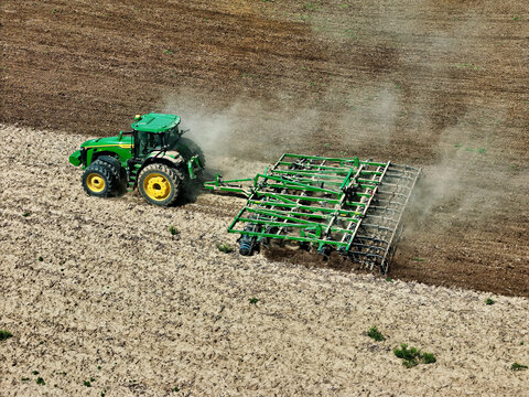Maquoketa, Iowa - USA - May 15, 2024: John Deere 8R 370 tractor pulling a John Deere 2310 Mulch Finisher