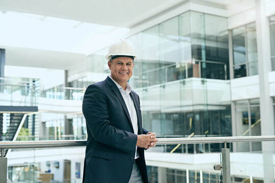 Mature, businessman and smile of architect with portrait for project management, property planning and hard hat. Contractor, professional person and happy for engineering, building planner and pride
