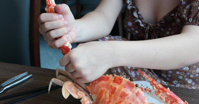 video of a girl cutting crab at a buffet table