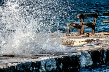 Waves crashing against a rock on the coast.
