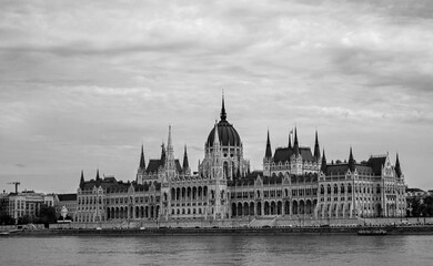 Black and White dramatic image of Parliament Building on the waterfront of River Danube in Budapest.