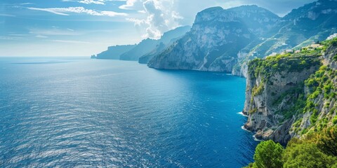 A beautiful landscape of the Amalfi Coast in Italy. The photo shows a rugged coastline with sheer...