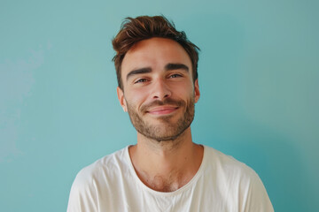 A close up portrait of a young man with a subtle smile