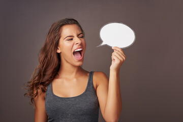 Woman, speech bubble and shout in studio background for product advertisement, promotion and sale. Female person, screaming and energy with sign board for instructions, information and tips in mockup