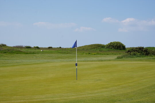 golf course landscape with flag on par 3 hole. sport activity. summer scene on golf course