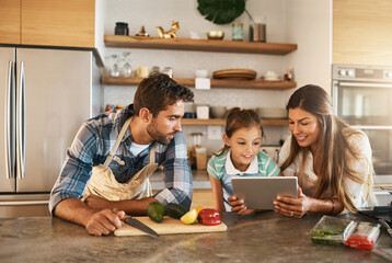 Food, nutrition and diet with people, tablet and ingredients for salad recipe on kitchen counter for dinner. Family, healthy and meal prep with with avocado, pepper and pasta for clean eating in home