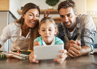 People, child and meal prep with phone, online for social media or post on kitchen counter for dinner. Family, healthy and food or cooking for nutrition, together or bonding for clean eating in home