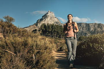 Naklejka premium Portrait, hiking and woman with nature, walking and outdoor for adventure, wellness and journey. Person, hiker and healthy girl with environment, mountain and cardio with vacation, energy and travel