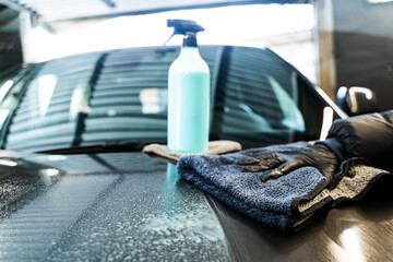 Applying quick detailer, spray and wiping to make clean and shine car surface. Polishing car body...