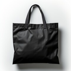 Naklejka premium A black tote bag with two handles sits on a white background.