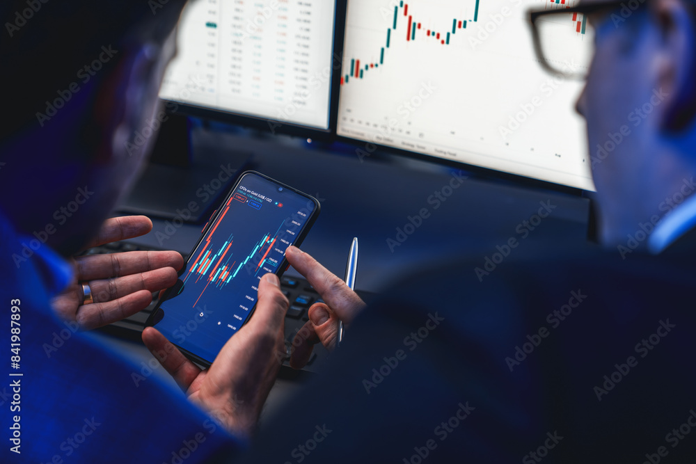 Poster two stock exchange traders researching data on smartphone and laptop screen server of dynamic digita