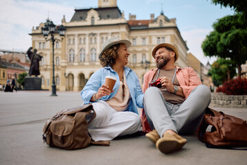 Happy mature couple having fun while relaxing after sightseeing in city.