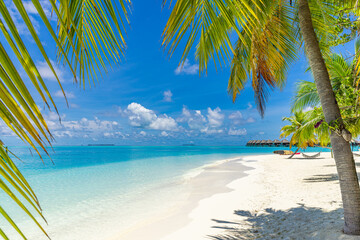 Amazing travel landscape. Luxury hotel with water villas and palm tree leaves over white sand,...