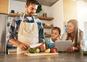 Family, cooking and diet with people, tablet and ingredients for salad recipe on kitchen counter for dinner. Healthy, food and meal prep with nutrition, together and bonding for clean eating in home