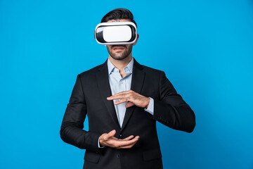 Smart business man with suit holding something while VR goggle to connect metaverse. Professional...