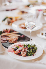 food on a white tablecloth. many different dishes arranged on the table view of the chef in a restaurant. 