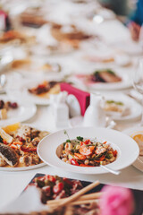 food on a white tablecloth. many different dishes arranged on the table view of the chef in a restaurant. 