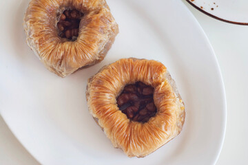 Cake with honey and walnuts in a plate on the table