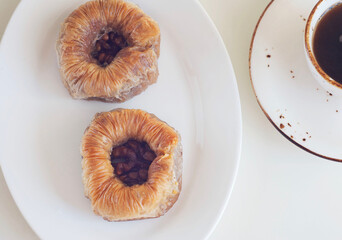Cake with honey and walnuts in a plate on the table