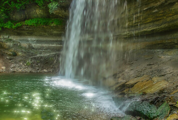 Bridal Veil Falls on Manitoulin Island Ontario, silky waterfall effect, sunlight glinting on water, daytime, nobody