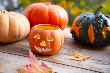 Autumn harvest, Set table with pumpkins, Yellow Leaves, Jack-o'-lantern candlelight, autumn decorations for Halloween, Holiday Preparation