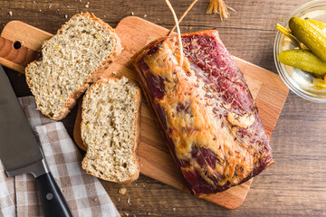 Sliced Bread With Caraway-Spiced Bacon on Wooden Cutting Board