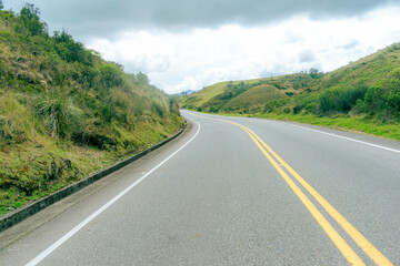 mountainous landscape with a road that disappears into the horizon