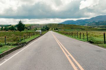 mountainous landscape with a road that disappears into the horizon