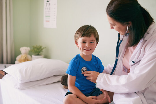 Doctor, stethoscope and child in hospital for healthcare, health and wellness with medical exam. Female pediatrician, assessment and patient in clinic for heart, lungs and cardiology with portrait
