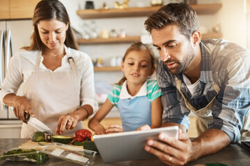 Parents, child and cooking with tablet, online for recipe or ingredients on kitchen counter for dinner. Family, healthy and food for meal prep, nutrition and together with bonding for eating in home