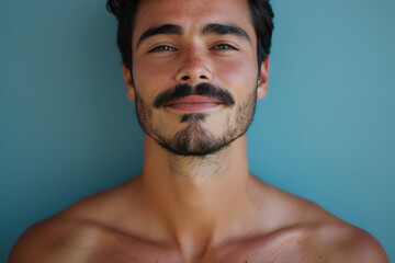 Fototapeta premium A close up portrait of a young man with a subtle smile