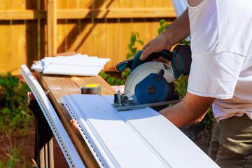 Prior to installing vinyl siding panels on craftsman facade, vinyl siding panels are cut to desired...