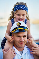Sailor, portrait or kid at sea with father or captain at ocean for service duty, reunion or love at harbour. Happy, shoulders and dad with girl for travel return or patriotic hero, family or navy