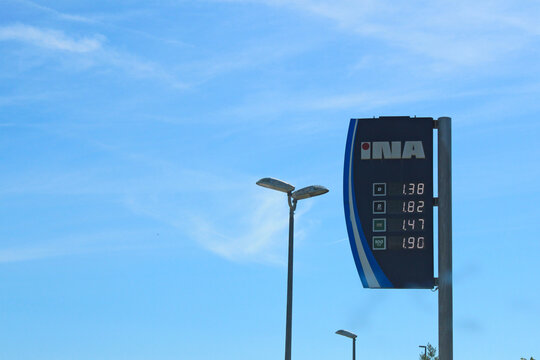 Krk, Croatia Ina Gas station, 06.06.2024, 
 price sign showing fuel costs against a blue sky with clouds, reflecting rising prices. Perfect for energy and automotive concepts