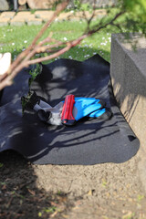 Laying an anti-weed mat in the garden together with paving stones and decorative pebbles