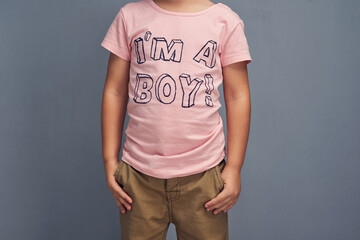 Kid, affirmation and text on shirt for gender identity, style and youth fashion model by gray...
