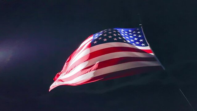 A United States flag flies in a canyon in Utah County
