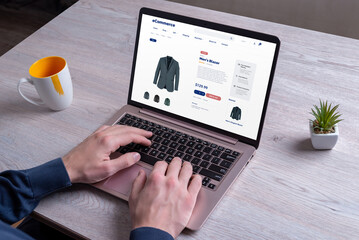 Shopping for men's blazers online, exploring various colors, using a laptop on an e-commerce...