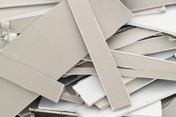 Drywall Gypsum material waste, cut into pieces, doing wall interior inside work, close up.