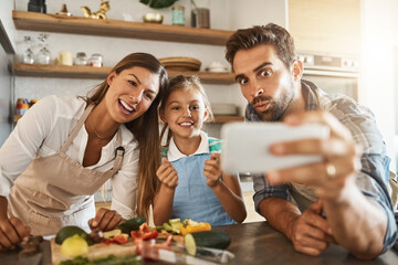 Parents, child and cooking in selfie for post, online and social media in bonding in kitchen as family. People, healthy and happy for meal prep, nutrition and together with funny for sharing in home