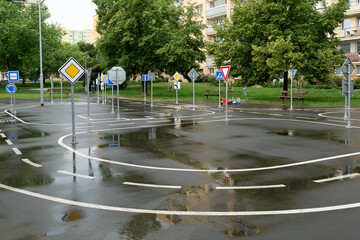 kid's playground designed as a mini road with signs, teaching transportation and traffic rules and safety through play. Located in Prague, Europe.