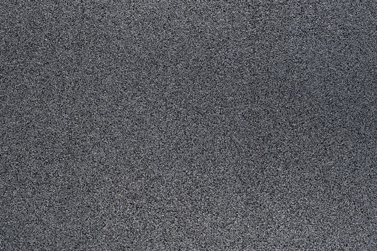 surface of a rubber hydro pad made from recycled car tires. This new modern building material for street roads and playground.  a close-up texture-filled frame. - Powered by Adobe